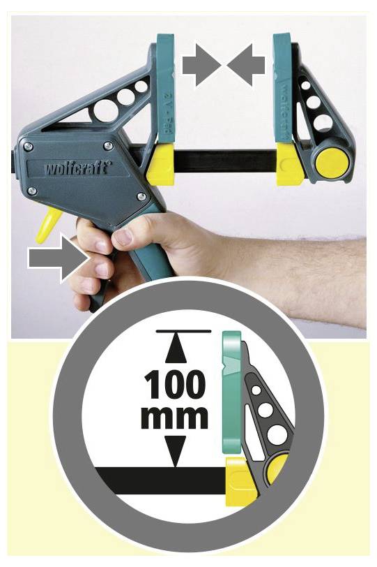 Ruka obsluhuje modro-žlutou svěrku Wolfcraft, která ukazuje měření 100 mm na detailní grafice níže.