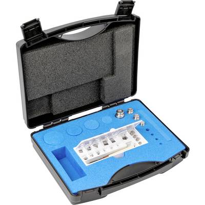 Otevřený černý kufřík obsahuje bílé elektronické zařízení a několik kovových komponent, zasazených do modrové pěnové výplně.