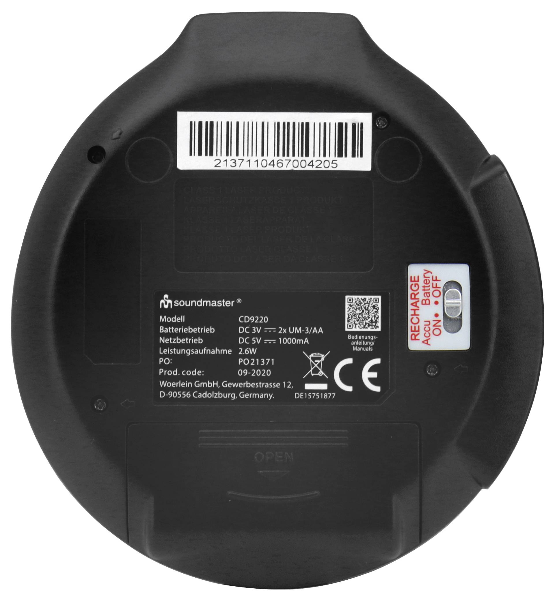 Dolní pohled na kulaté zařízení Soundmaster se štítkem modelu D9220, čárovým kódem, značkou CE, pouzdrem na baterii a spínačem ZAP/VYP se označením "AC/DCE".