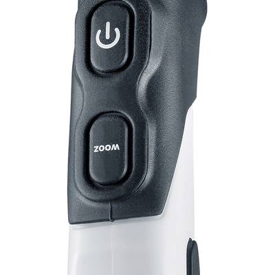Detailní záběr zařízení se dvěma tlačítky: Zapnuto/Vypnuto a 'ZOOM', obě v černé barvě na světlém pozadí.