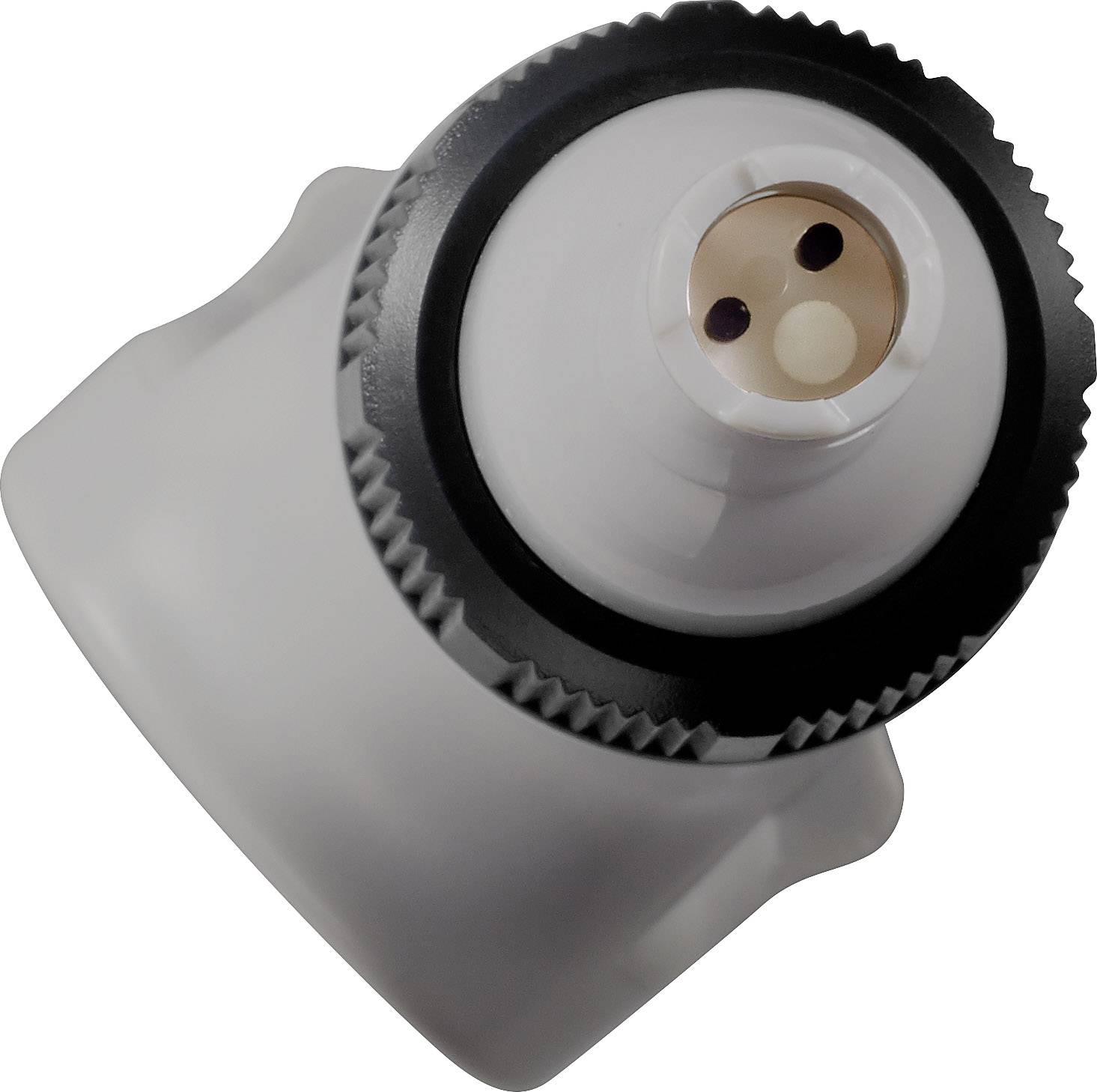 Pohled na objekt s kruhovým, zuborně tvarovaným okrajem a centrální kruhovou částí se dvěma pozlacenými kontakty.