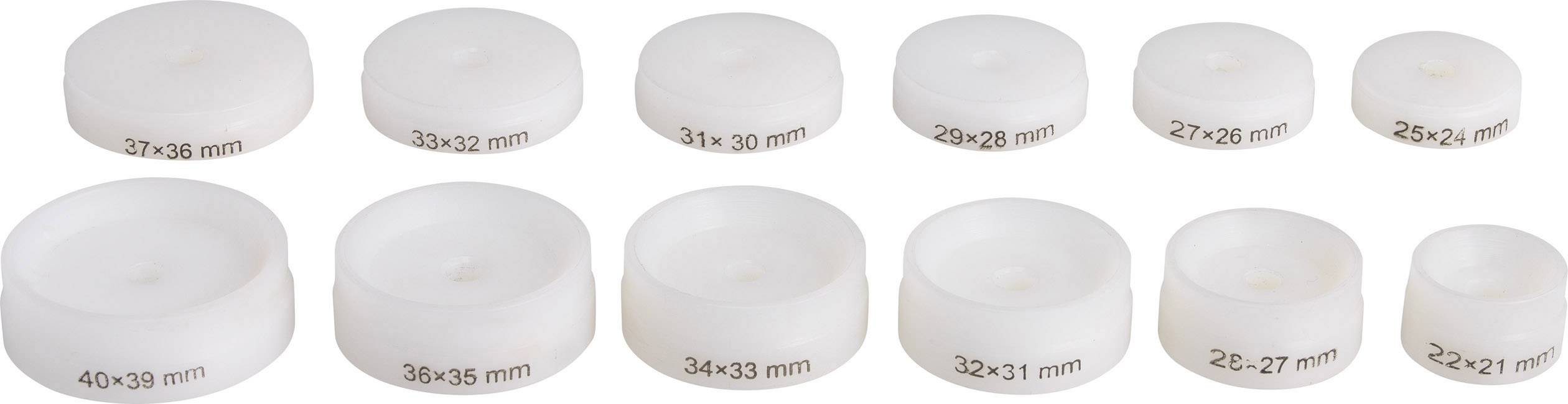 Různé bílé plastové disky ve zmenšující se velikosti od 40x39 mm do 22x21 mm, uspořádané ve dvou řadách zleva doprava.