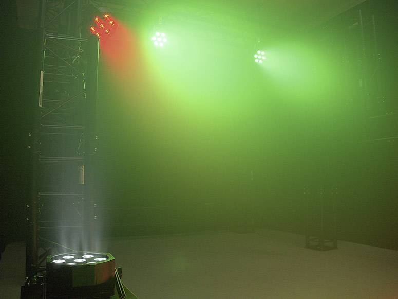 Jevištní osvětlení s červenými a zelenými reflektory, které vytvářejí atmosférickou náladu.