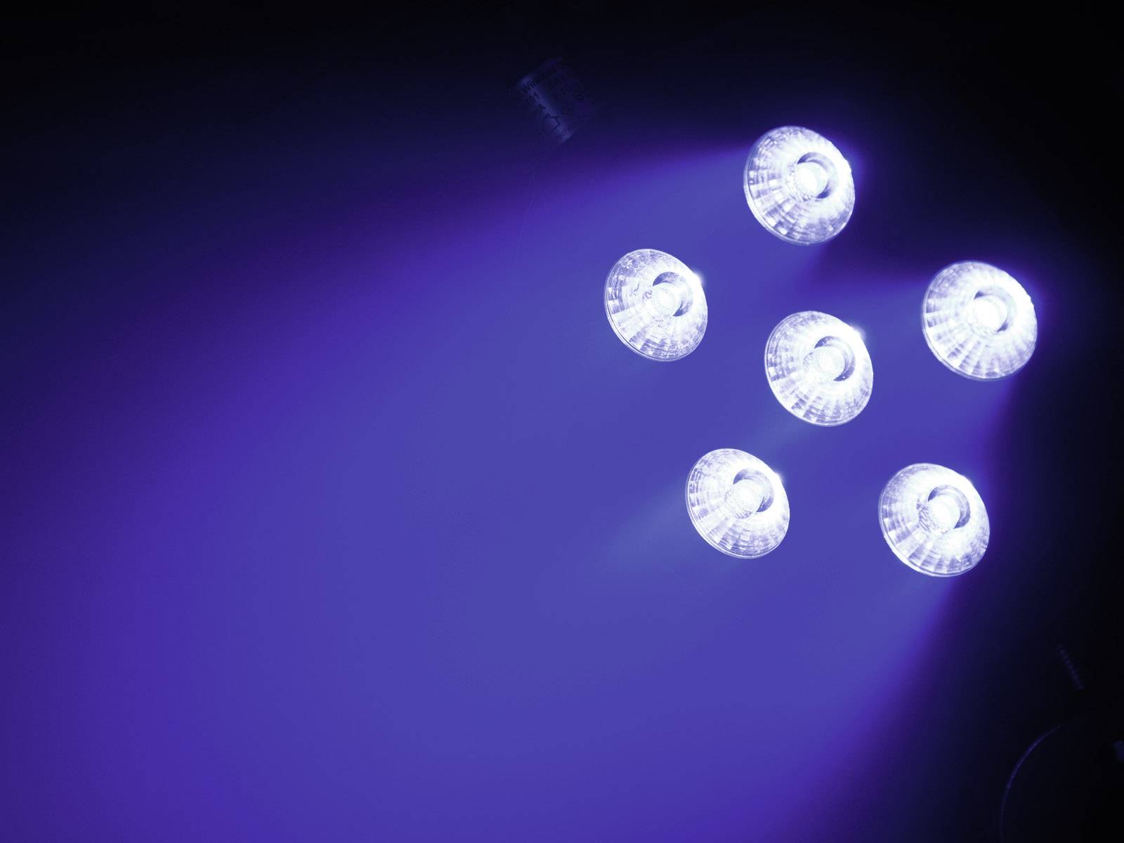 Šest jasně svítících LED lamp v tmavém prostředí vyzařuje modré světlo.