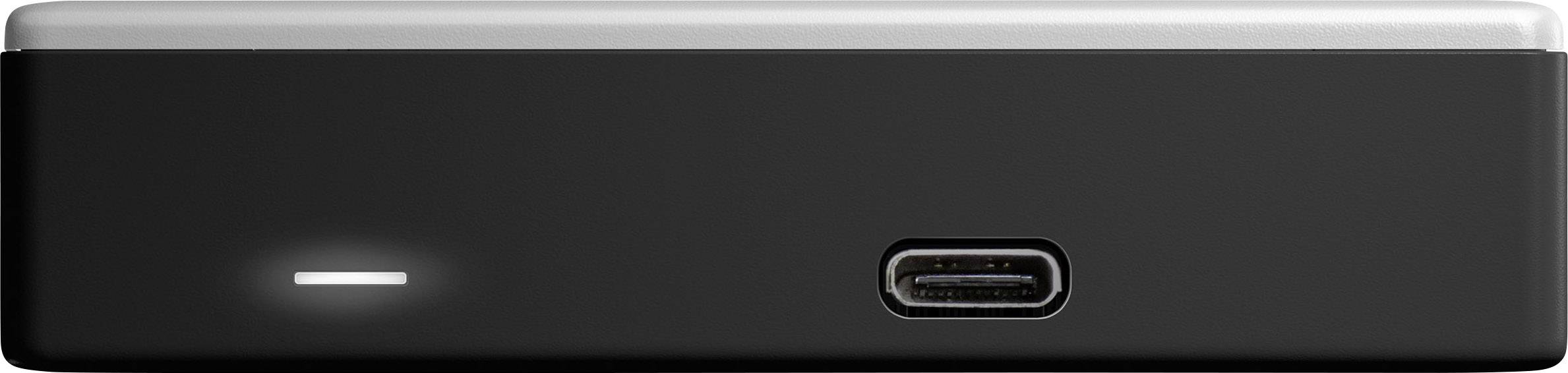 Malé, černé elektronické zařízení s USB-C konektorem na přední straně a svítícím LED indikátorem vlevo.