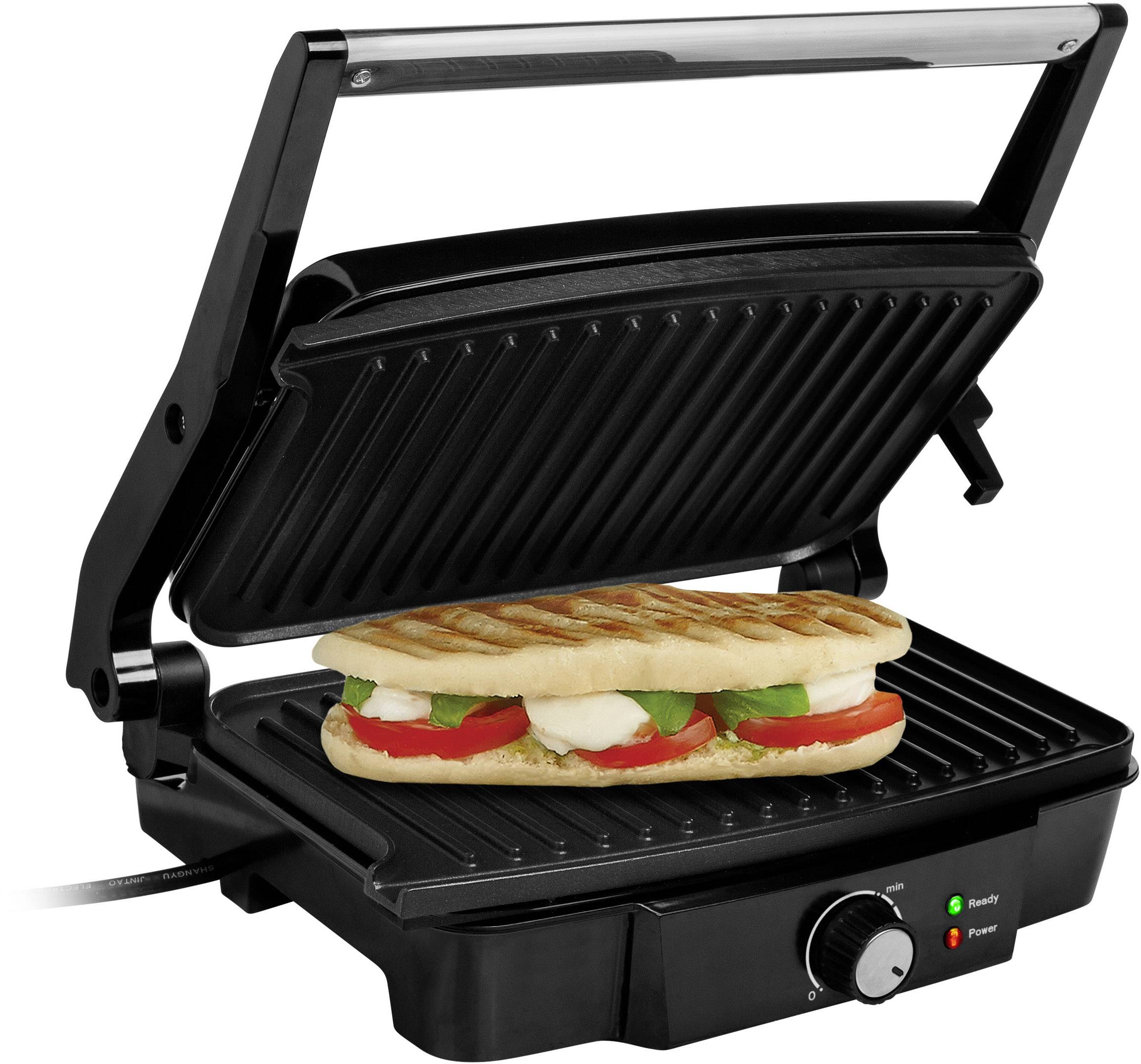 Sendvičový gril s grilovaným panini, plněným rajčaty, mozzarellou a bazalkou mezi černými žebrovanými deskami.