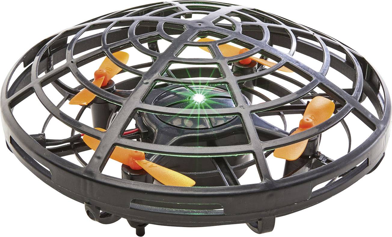 Malý dron s černými ochrannými mřížkami a oranžovými rotačními listy. Uprostřed svítí zelený světelný indikátor.