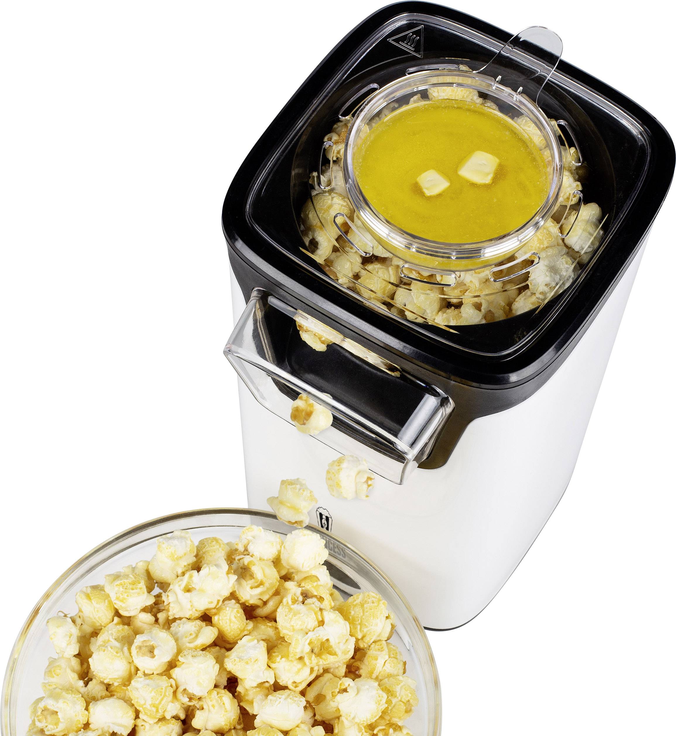 Stroj na popcorn s nástavcem na máslo nahoře; miska s čerstvě připraveným popkornem před strojem.