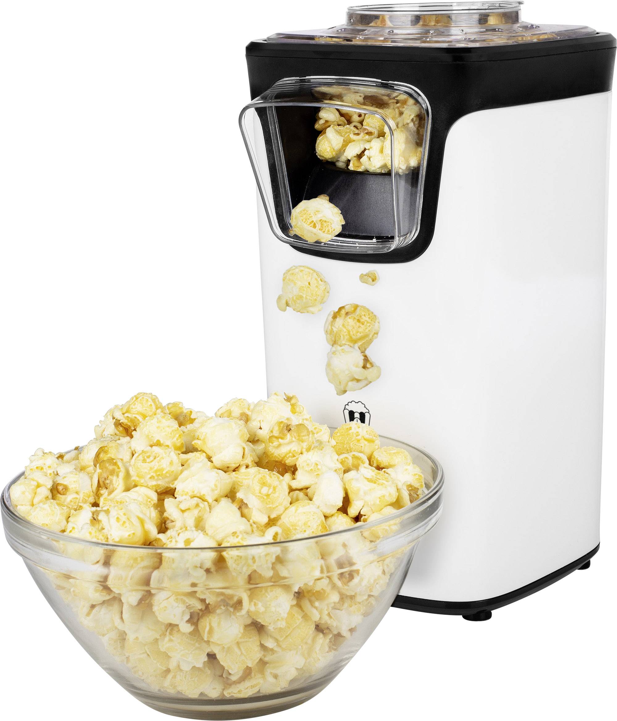 Bílý přístroj na popcorn, který hází popcorn do skleněné mísy. Popcorn padá předním výdejním otvorem na přístroji.