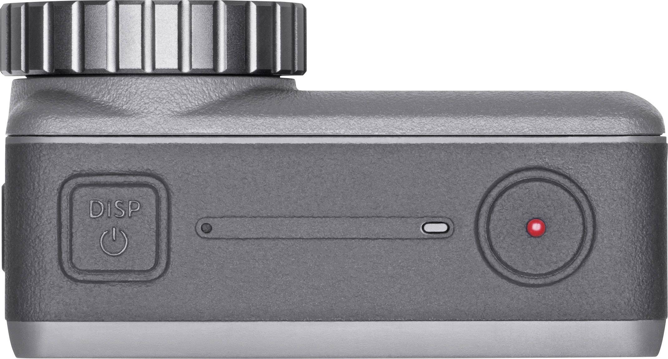 Kompaktní akční kamera pohledem z boku, s velkým otočným voličem nahoře a červeným tlačítkem záznamu vpředu.