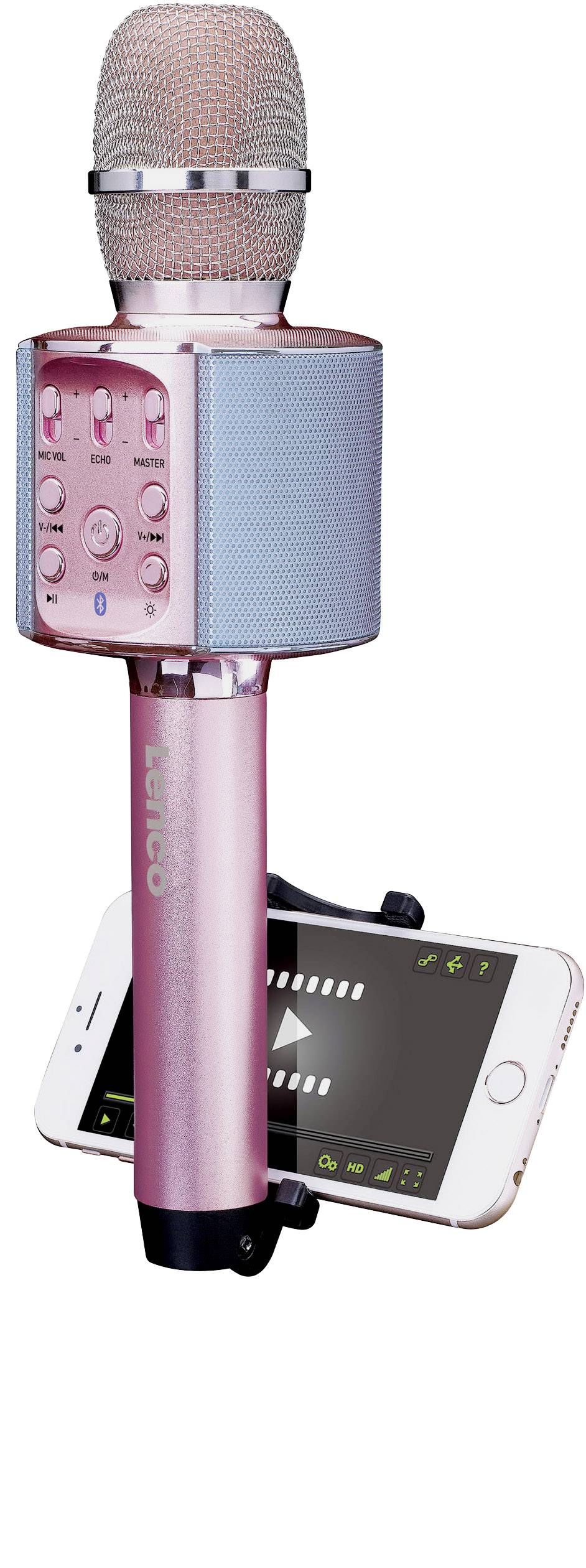 Růžový karaoke mikrofon s integrovanými reproduktory a funkcí Bluetooth, připevněný k mobilnímu telefonu, na bílém pozadí.