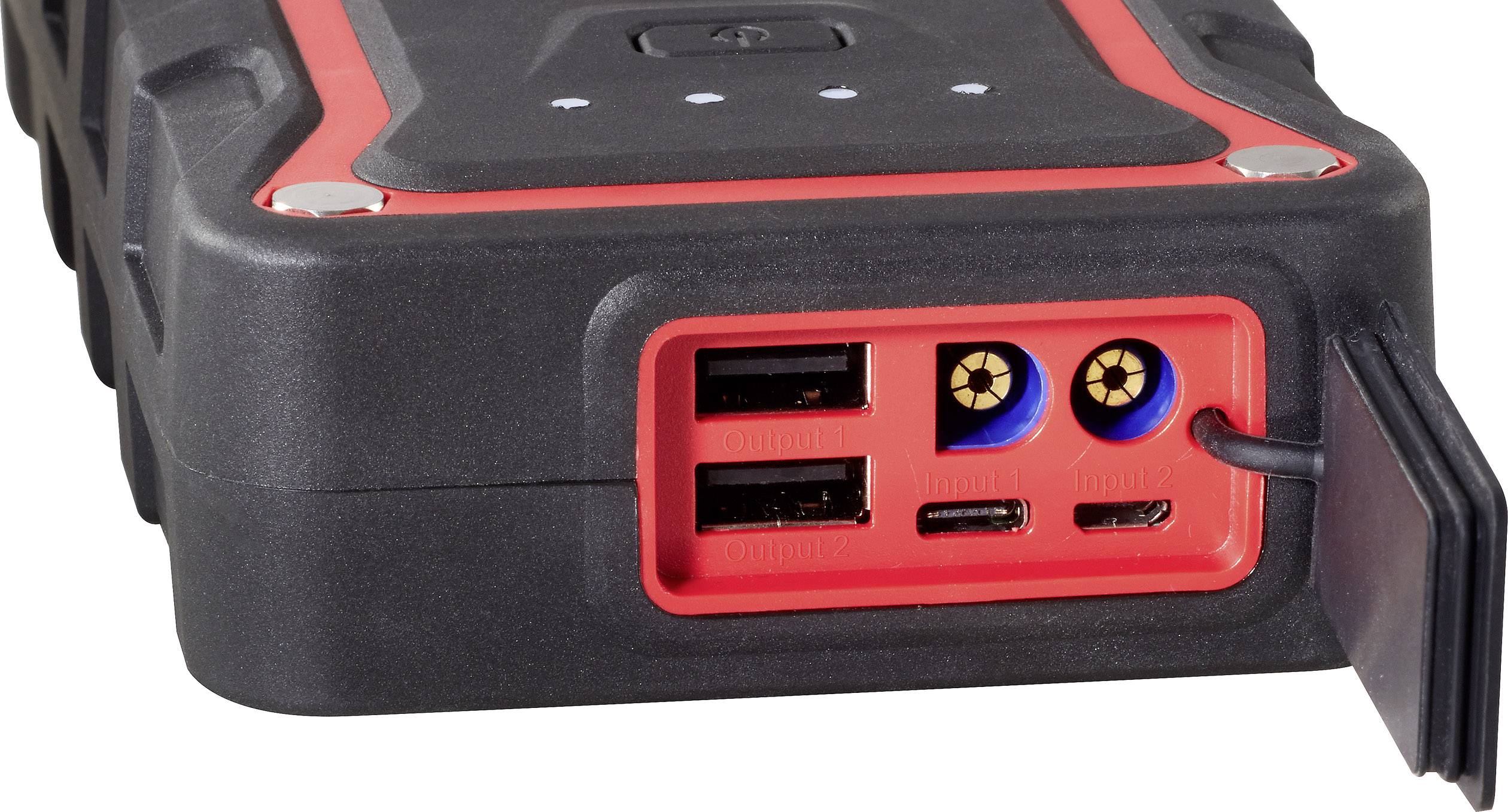 Přenosná záložní baterie s dvěma USB porty, jedním DC výstupem a uzavřeným gumovým oddílem pro kabelové připojení.