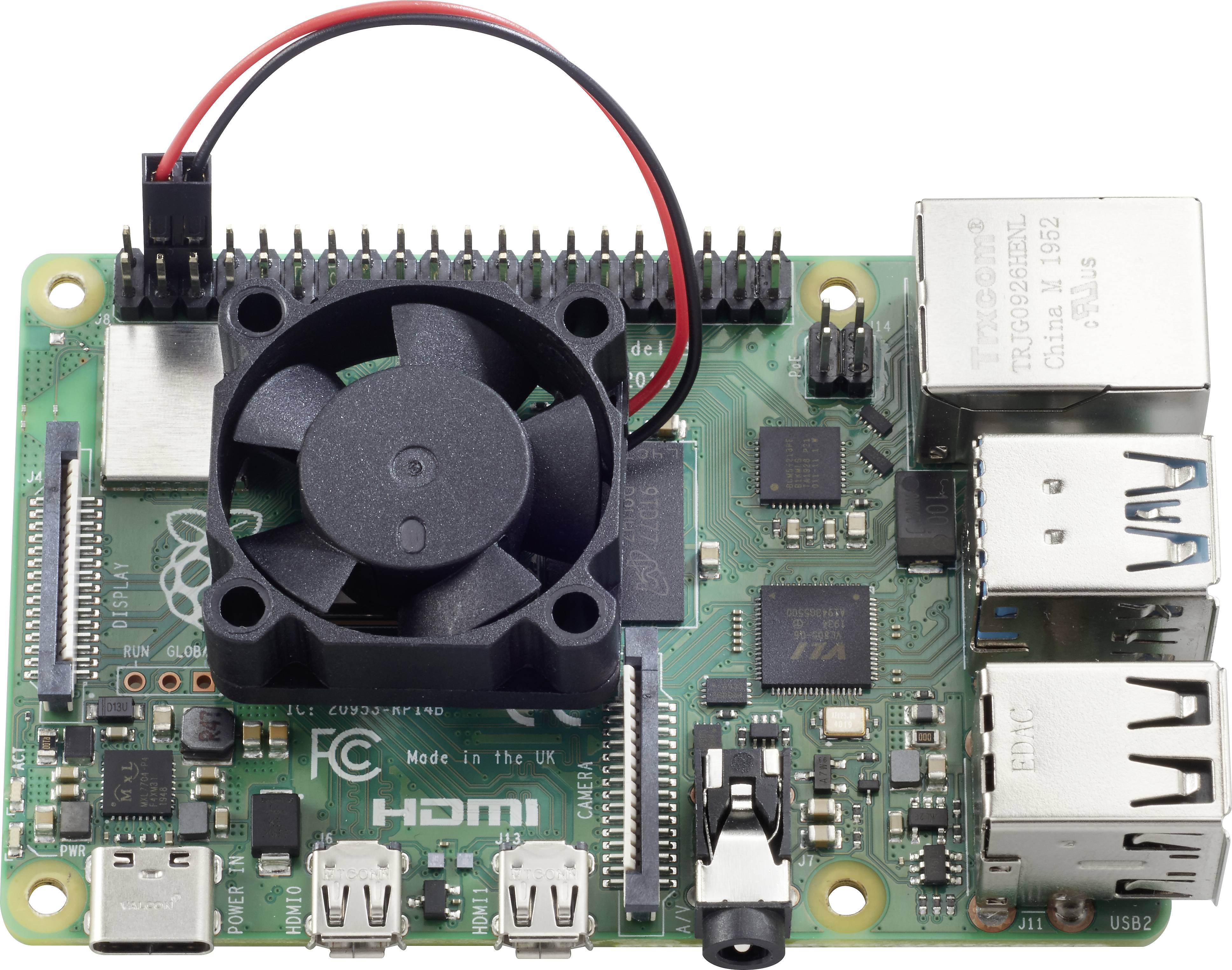 Deska plošných spojů s ventilátorem, USB a ethernetovými porty. Popisky: 'HDMI', 'Vyrobeno ve Spojeném království'. Vypadá jako model Raspberry Pi.