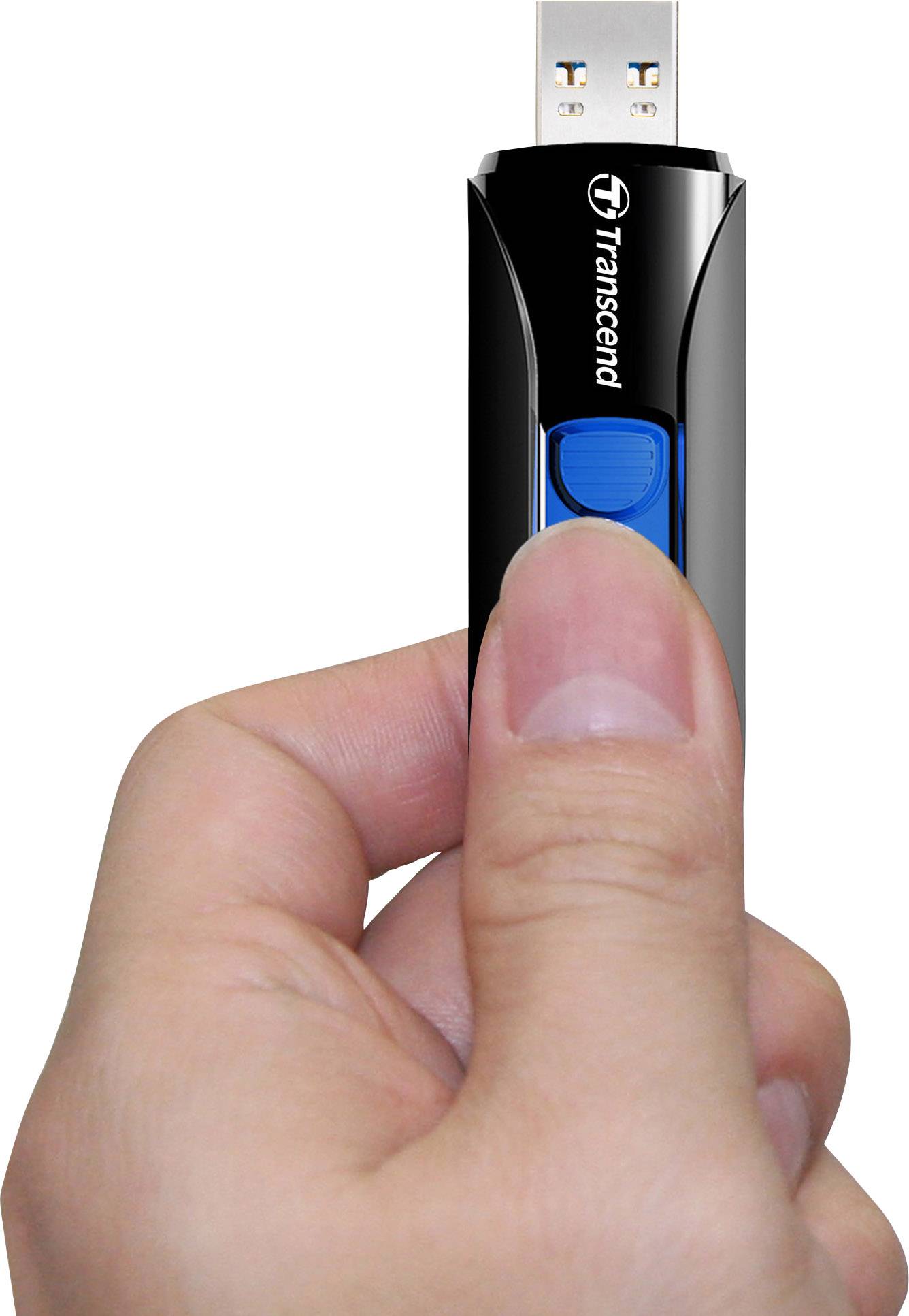 Ruka drží černý USB flash disk značky Transcend s modrým posuvným ovladačem.