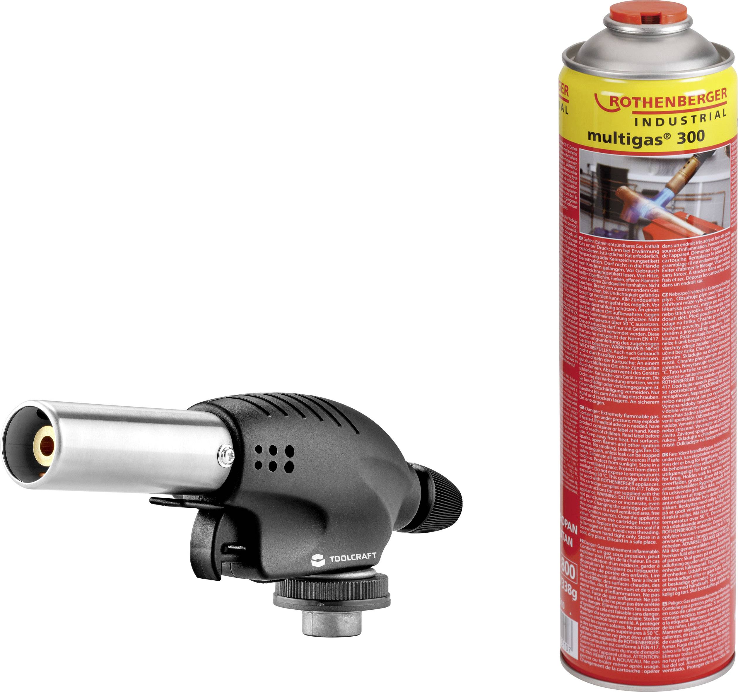 Na obrázku je černý plynový hořák vedle červené kartuše Multigas-300. Hořák je kompaktní a odkazuje na řemeslné použití.