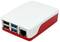 Malý počítač v bílém a červeném obalu s několika USB porty a ethernetovým připojením, vhodný pro jednoduché úkoly.