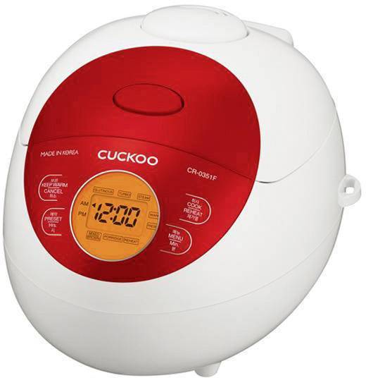 Elektrický rýžovar s digitálním displejem, zobrazuje čas '12:00 odp.'. Potisk: Značka 'Cuckoo', model 'CR-0351F', barva červeno-bílá.
