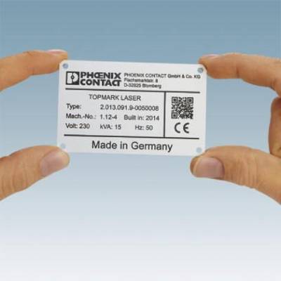 Dvě ruce drží obdélníkový štít s nápisem 'PHOENIX CONTACT' a 'Made in Germany'. Obsahuje technické detaily.