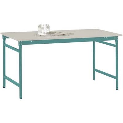 Stabilní stůl se zeleným kovovým rámem a bílou stolní deskou. Na stole stojí malý model a kovový nástroj.