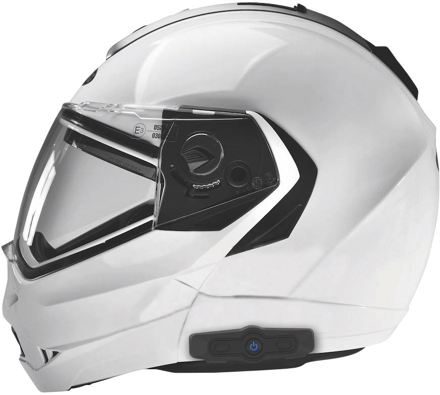 Bílá motocyklová helma s hledím, pohled z boku. Na levé straně je patrný vestavěný komunikační systém.