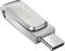 Stříbrný USB flash disk SanDisk s USB-C konektorem, zobrazený na bílém pozadí.