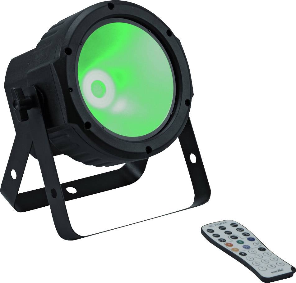 Černý LED reflektor svítí zeleně; vedle něj leží dálkový ovladač s několika barevnými tlačítky pro ovládání osvětlení.