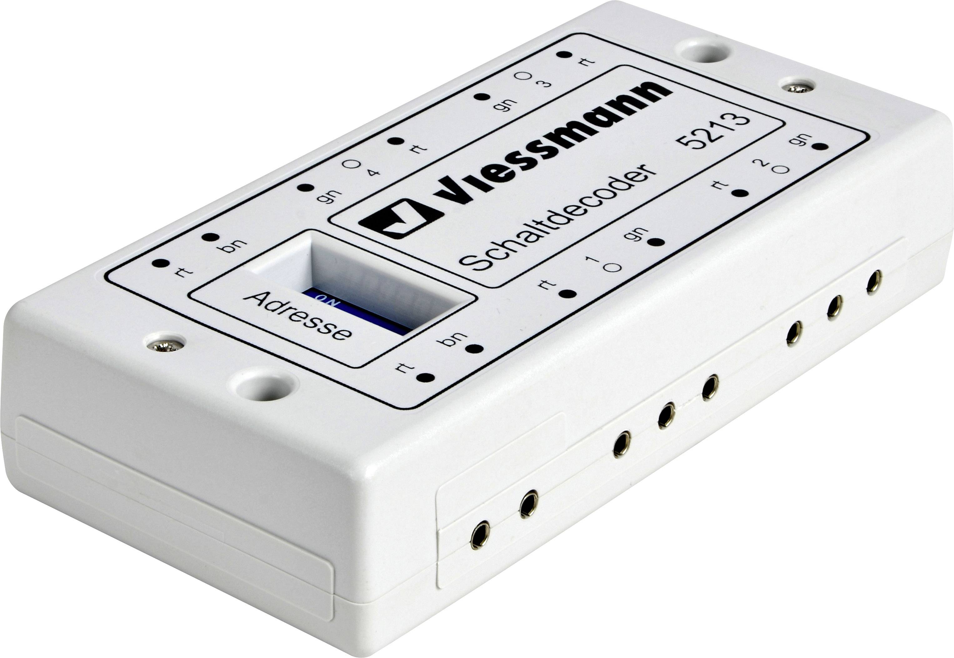 Obdélníkový bílý spínací dekodér 'Viessmann Schaltdecoder 5213' s popiskami a několika připojovacími zdířkami na stranách.