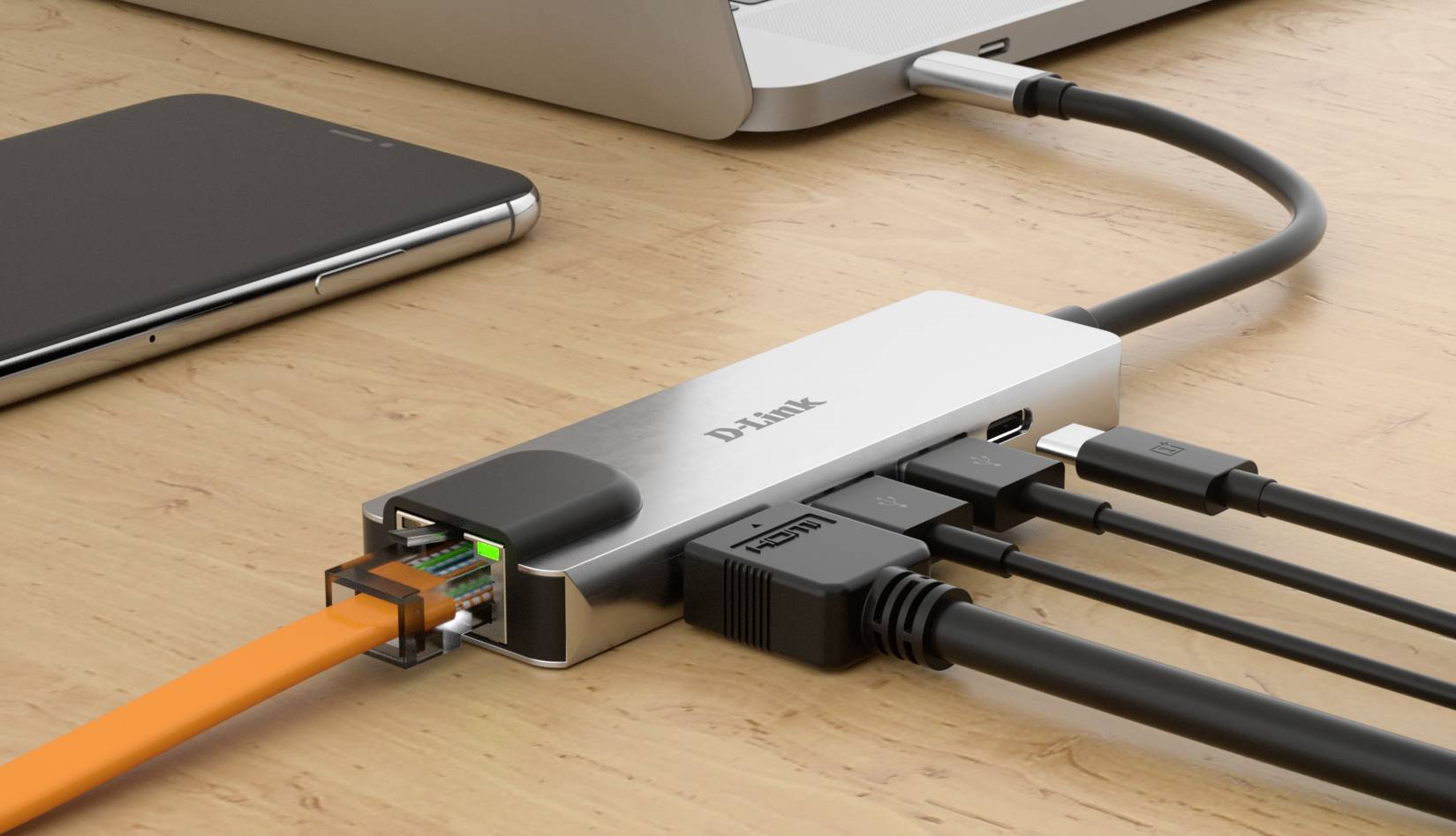 Laptop je připojen k USB-C rozbočovači, který podporuje několik kabelů, včetně ethernetového, HDMI a USB připojení, čímž rozšiřuje počet dostupných portů.