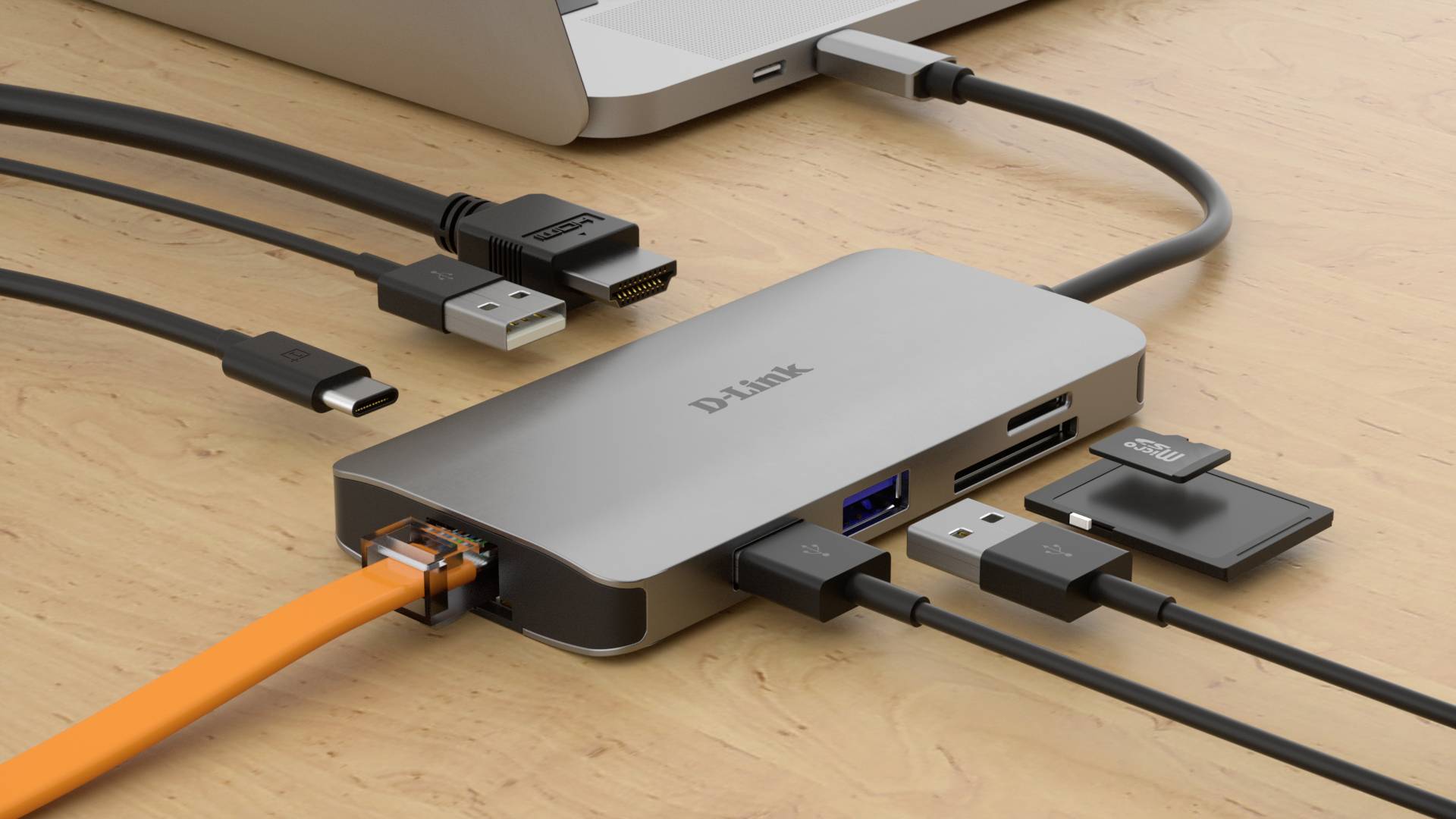 Laptop připojený k USB-C rozbočovači. Rozbočovač disponuje několika porty: HDMI, USB, Ethernet, čtečkou SD karet a čtečkou mikroSD karet.