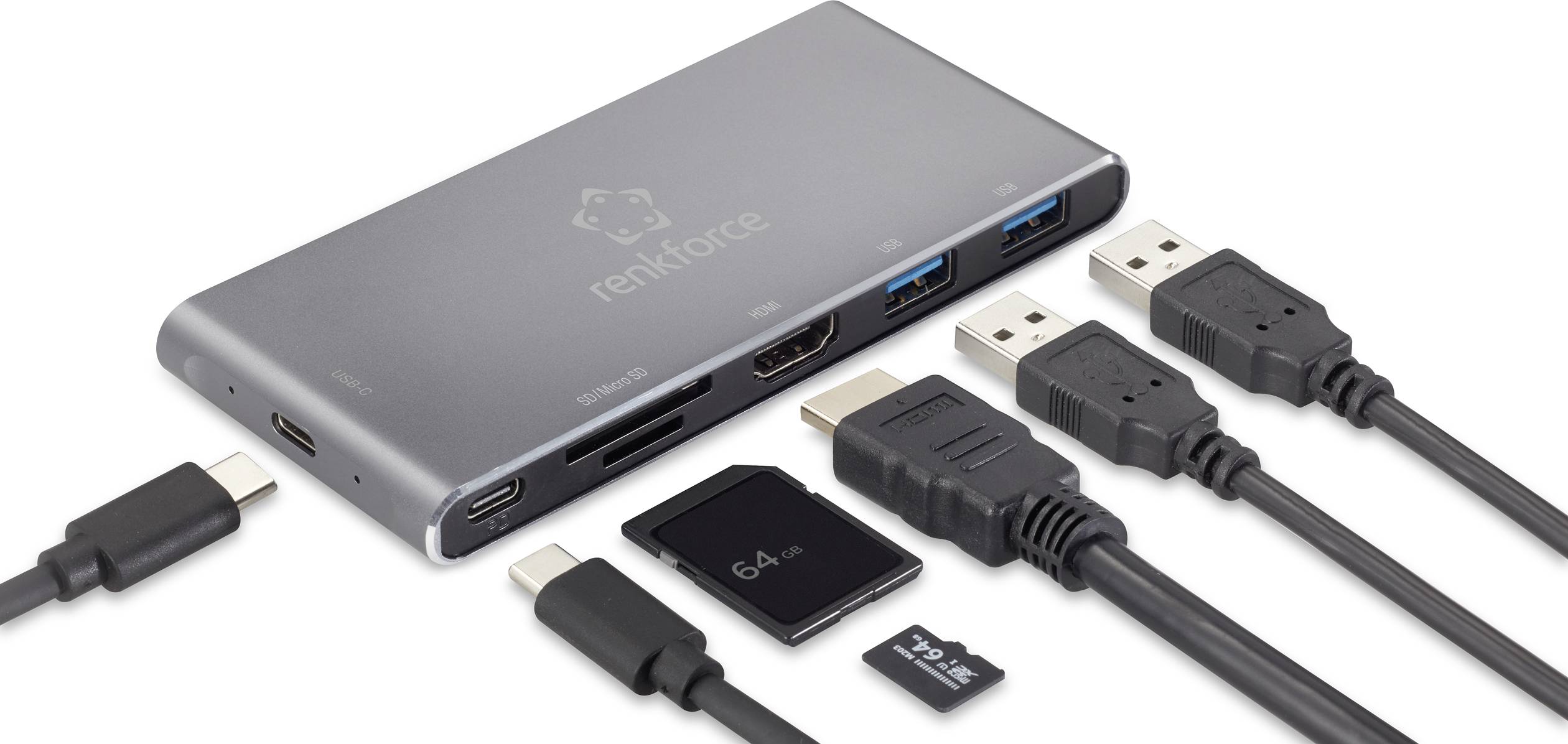Šedý USB rozbočovač s několika porty: HDMI, USB-A, USB-C, sloty pro SD a microSD karty. Vedle několik kompatibilních kabelů a karet.