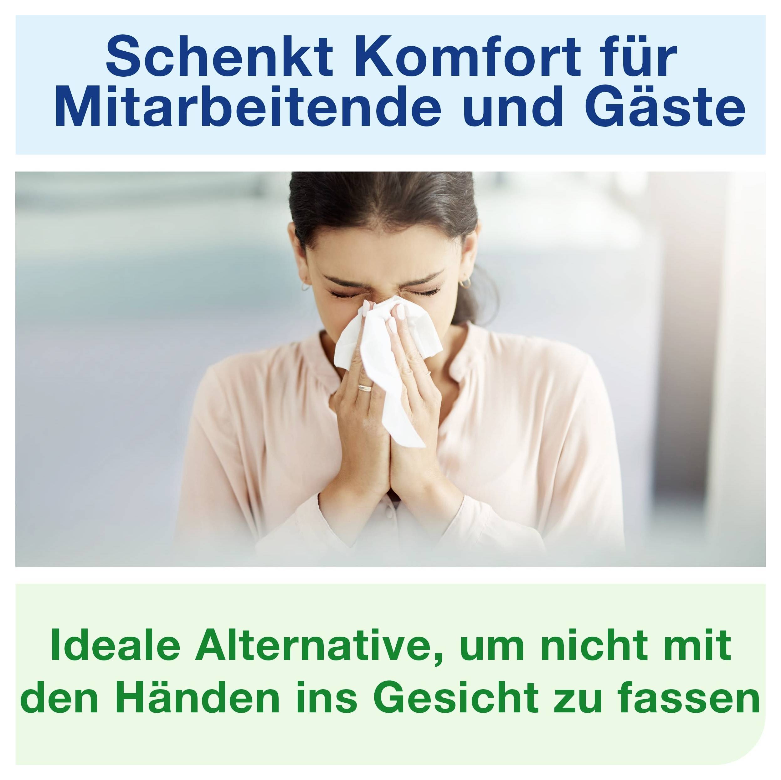 Reklamní plakát se ženou, která si čistí nos kapesníkem; Text: 'Poskytuje pohodlí pro zaměstnance a hosty' a 'Ideální alternativa, aby si lidé nemuseli sahat na obličej rukama'.