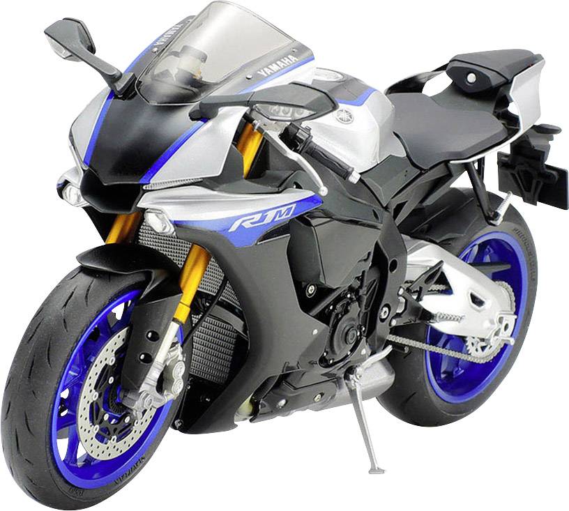 Sportovní motocykl v modré a stříbrné barvě stojí šikmo zepředu na stojanu.