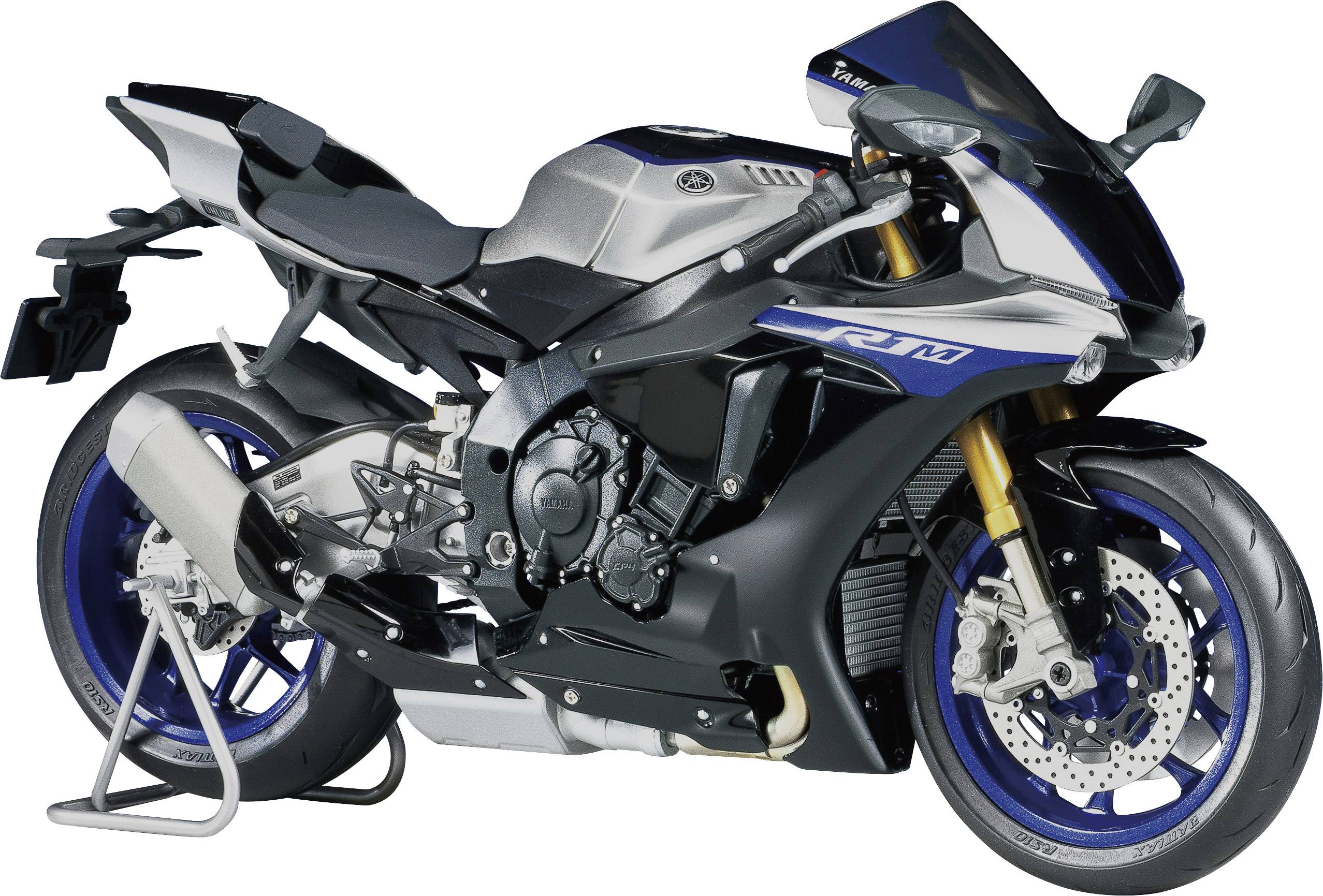 Motocykl v modré a šedé barvě na stojanu, sportovní design, boční pohled.