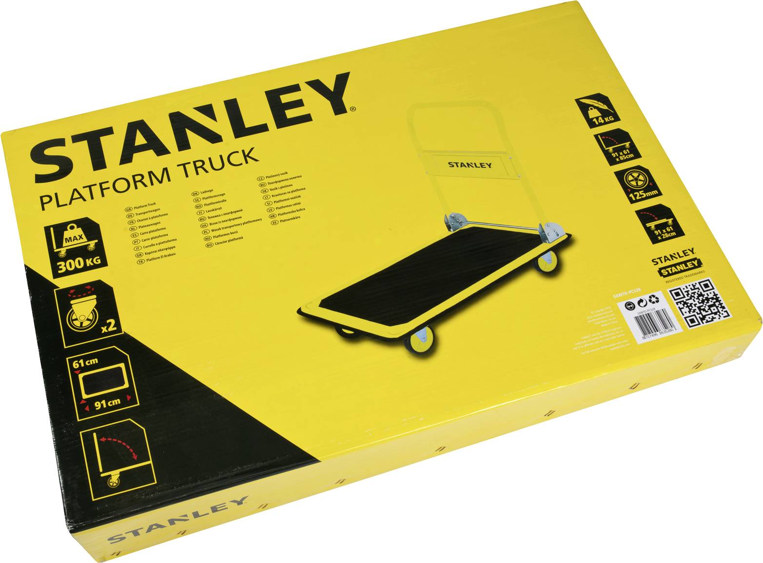 Žlutý obal plošinového vozíku od Stanley. Nosnost až 300 kg. Skládací na rozměry 61 cm x 91 cm. Obsahuje dva vozíky.