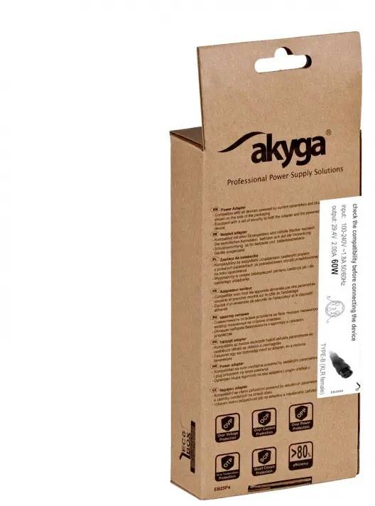 Hnědý produktový obal značky 'Akyga' s informacemi o napájecím adaptéru. Přední strana zobrazuje detaily a specifikace produktu.