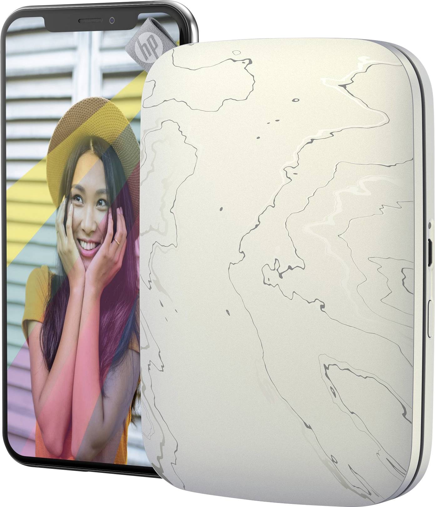 Přenosná fototiskárna vedle smartphonu. Na displeji smartphonu je žena s úsměvem, která má na hlavě klobouk.