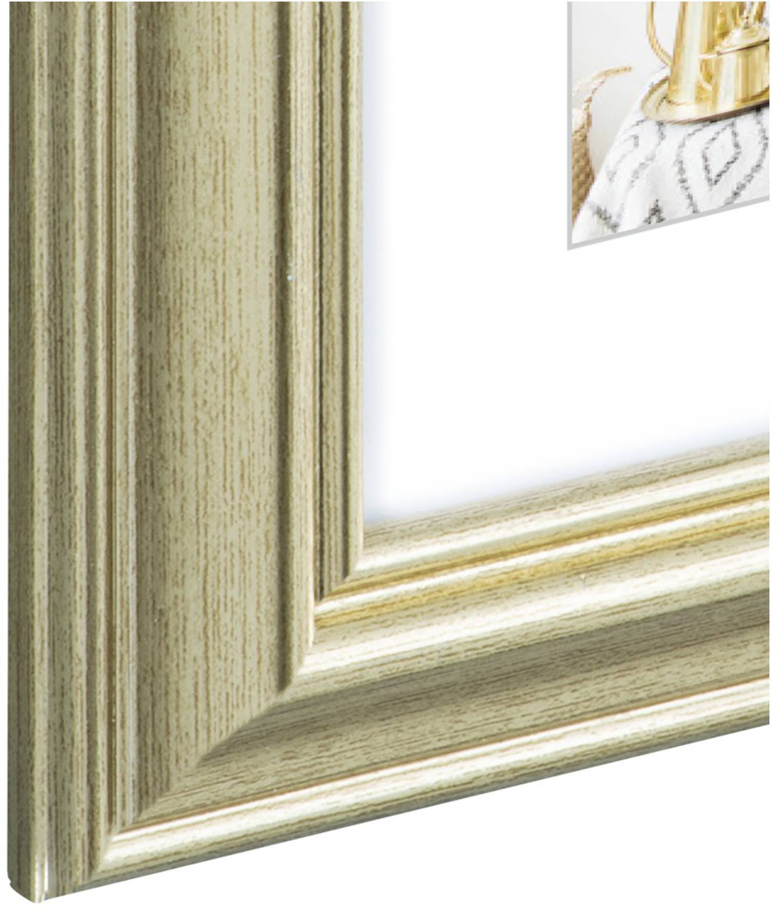 Zlatý rámeček s částí dekorativního obrazu v pozadí, který zobrazuje zlatou vázu na vzorované látce.