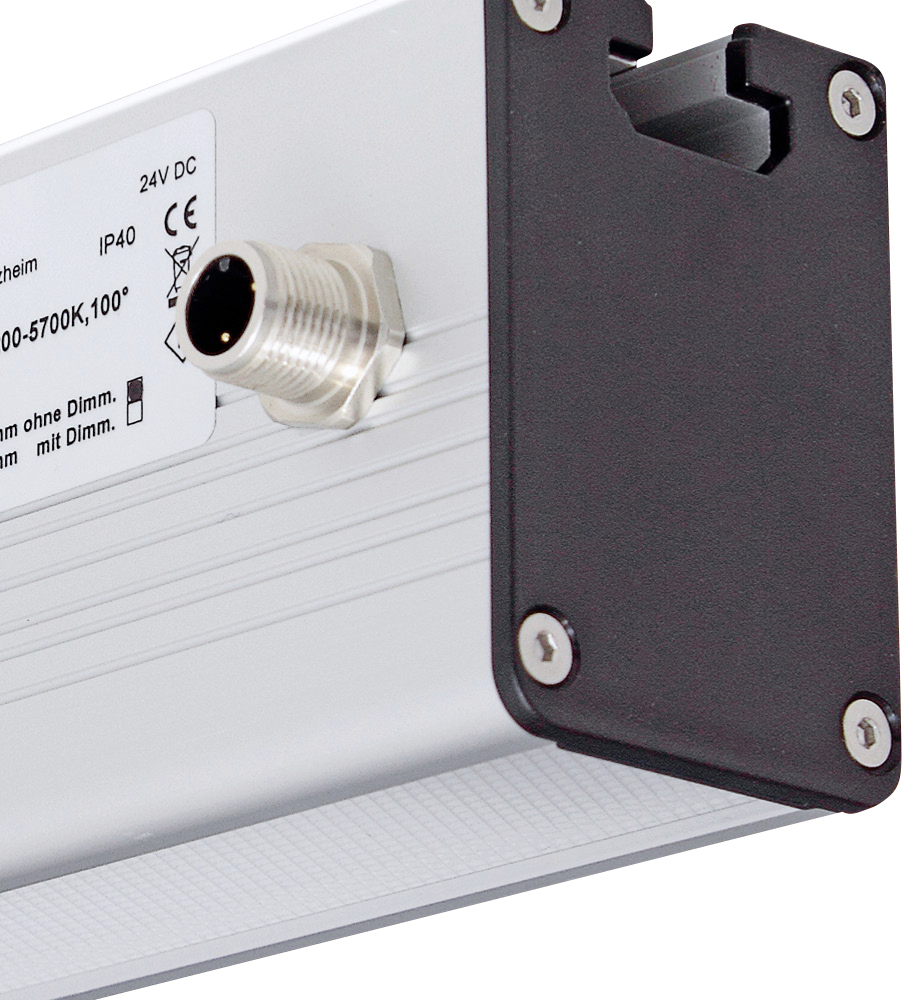Černostříbrné elektronické zařízení s označením '24V DC, IP40' a připojovací zásuvkou, boční pohled.