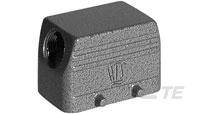 Obdélníkový šedý kovový kryt s logem neznámé značky na přední straně a dvěma viditelnými šroubovacími upevněními.