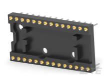 Na obrázku je černá elektronická zásuvka s několika zlatými kontakty, které slouží k technickému propojení.