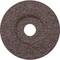 Tmavohnědý brusný kotouč s drsnou texturou a kruhovým otvorem uprostřed, často používaný pro broušení kovových povrchů.