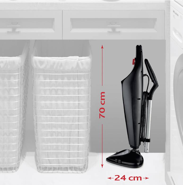 Vysavač ve vzpřímené poloze s rozměry 70 cm výšky a 24 cm šířky, stojící vedle dvou košů na prádlo pod skříní.