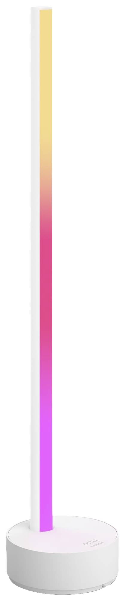 Stojací lampa s LED diodami měnícími barvu od žluté po růžovou, umístěná na kulatém bílém podstavci.