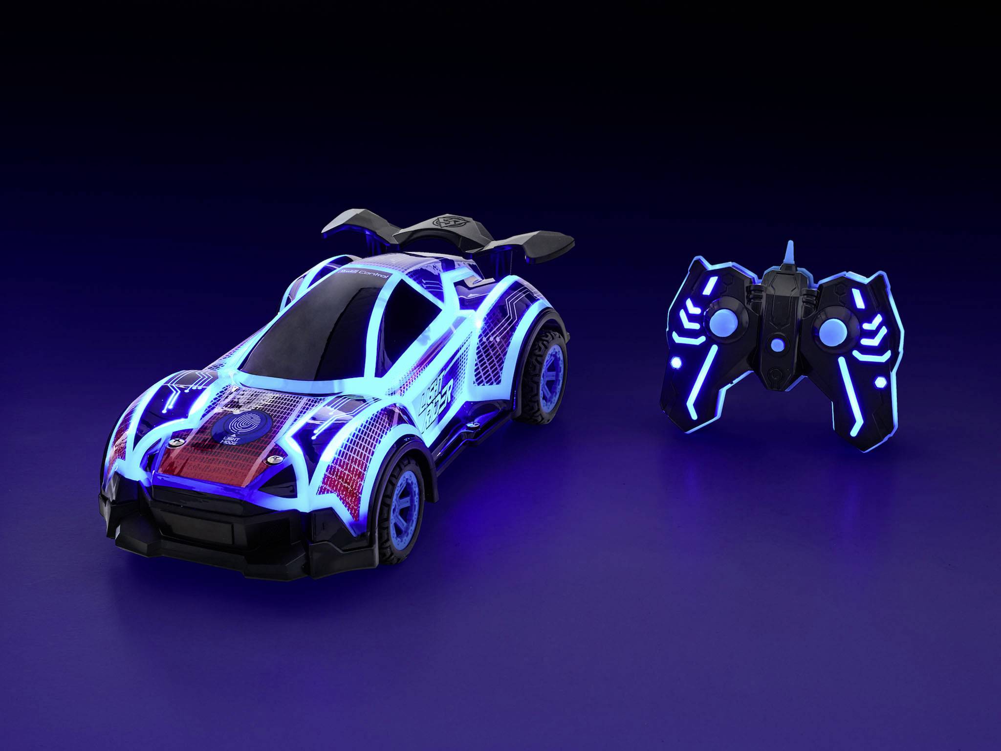 Futuristické, modře svítící dálkově ovládané auto s odpovídajícím ovladačem, vystavené na tmavém povrchu.