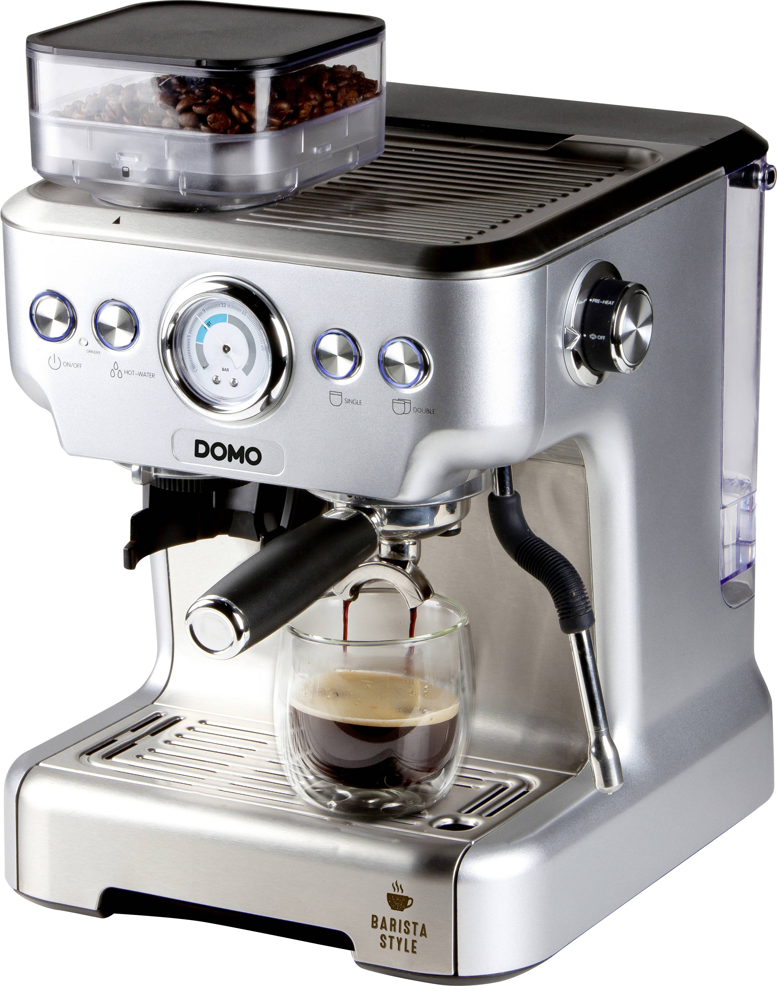 Stříbrný espresso kávovar se skleněnou konvicí dole, do které se nalévá káva. Nahoře zásobník na zrnka, několik přepínačů a tlakoměr.