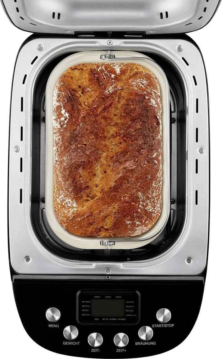 Čerstvý chléb z pekárny, zlatohnědá kůrka, hotovo. Přístroj s ovládacími prvky pro menu, váhu, čas a hnědnutí.