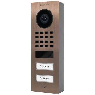 Měděně zabarvená videotelefon se dvěma jmenovkami: 'S. Martin' a 'C. Berger'.