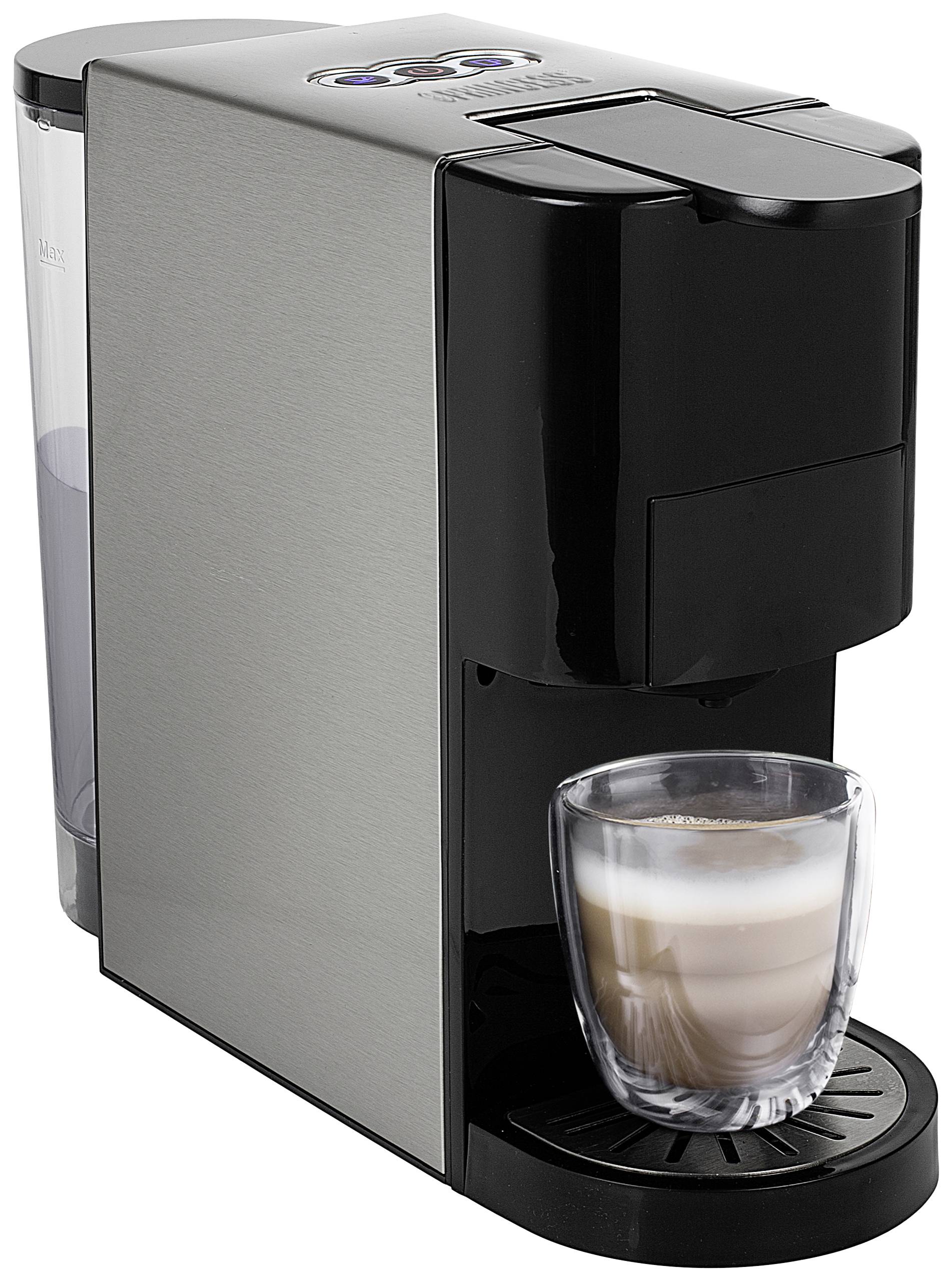 Černý espresso kávovar se stříbrným tělem připravuje latte macchiato ve skleněném průhledném šálku.