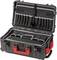 Otevřený kufřík na nářadí z tvrdého plastu s několika přihrádkami a kapsami, vhodný pro bezpečnou přepravu nářadí.