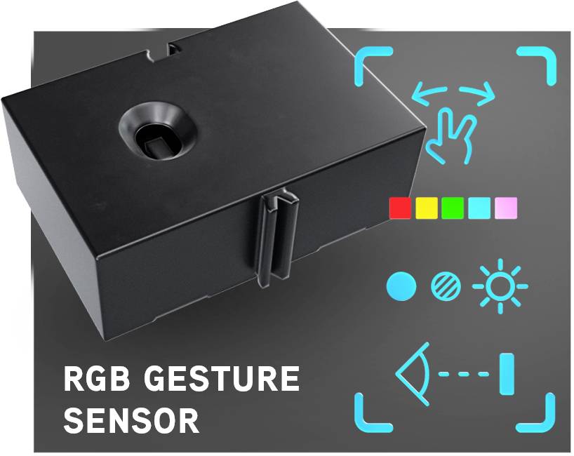 Černý RGB gesto senzor na tmavém pozadí. Symboly pro ovládání dotykem, jas a barvu. Text: 'RGB GESTO SENZOR'.